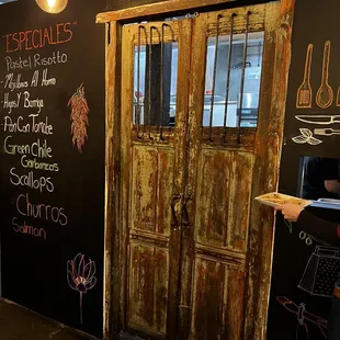 an old door and chalkboard