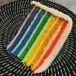 a slice of rainbow cake