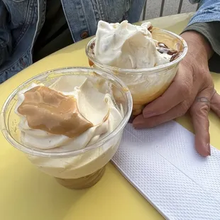 The large is the one with the ice cream barely sticking out of the same size cup of the medium.