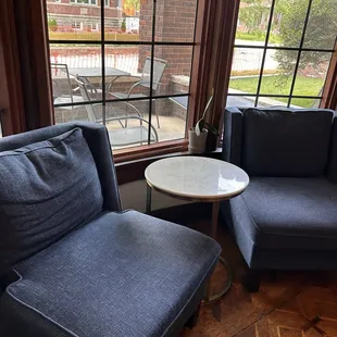 View of porch seating through window and indoor seating