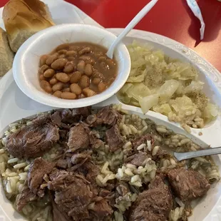 Stew beef over rice, pintos, stewed cabbage.