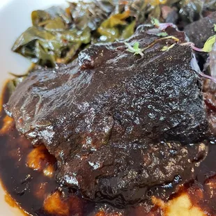 BBQ braised short rib with cheesy polenta and collard greens.