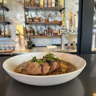 a bowl of soup on a bar counter