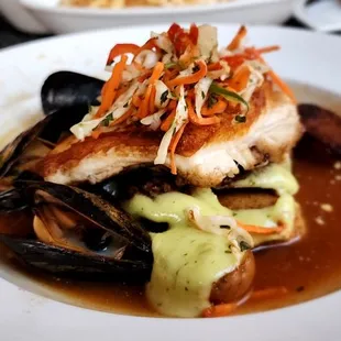 a plate of food with fish and vegetables