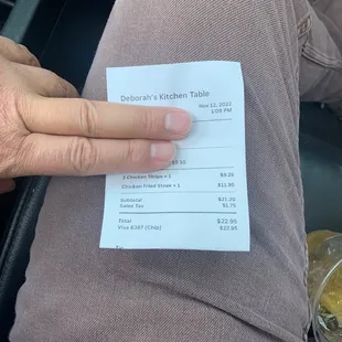 a person holding a receipt