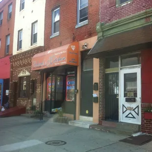 Front of store big orange awning