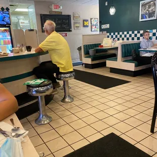 a man sitting in a diner
