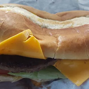 a hamburger with cheese and lettuce