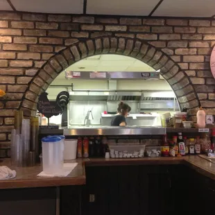 a kitchen with a brick wall