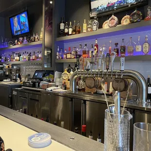 a bar with a lot of bottles of alcohol