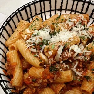 a bowl of pasta with meat and cheese