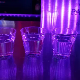 three shot glasses on a table