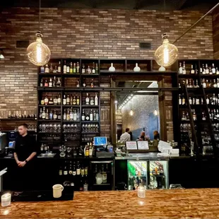 a man behind the bar at a restaurant