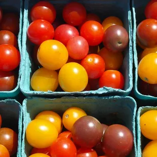 a variety of tomatoes in baskets