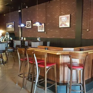 a bar with red stools