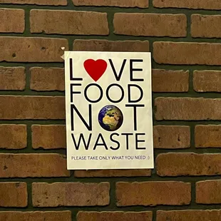 a sign on a brick wall
