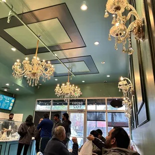 a group of people sitting at tables in a restaurant