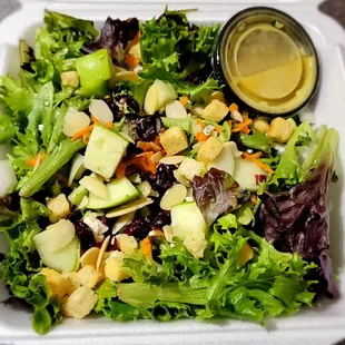 a salad in a styrofoam container