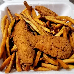 fried chicken and french fries in a styrofoam container