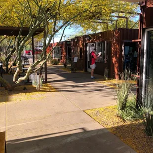 a woman walking down a sidewalk