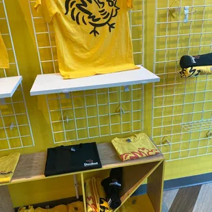 a yellow t - shirt on a shelf