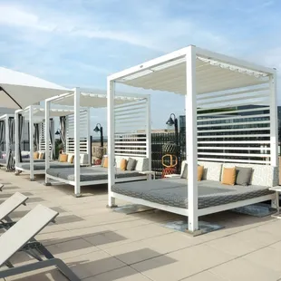 lounge chairs and umbrellas on a rooftop