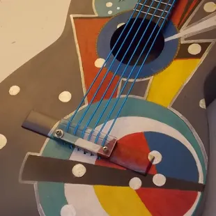 Wall art guitar with lighted strings.