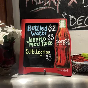 a coke bottle and a menu board