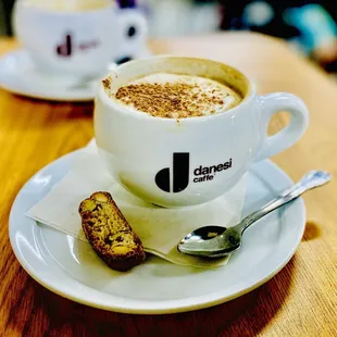 LOVE LOVE LOVE cappuccinos come with a tiny spoon &amp; biscotti. Superb. OuiOui. Winners Circle :)...