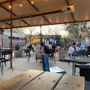 a patio area with tables and chairs