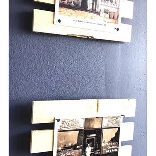 a couple of old photos hanging on a wall
