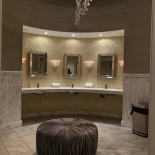 a circular bathroom with a chandelier