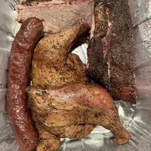  meat and sausage in a foil container