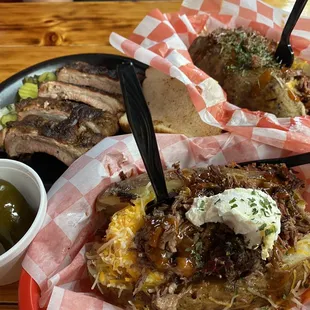 Loaded baked potato with chopped brisket and 1/2 lb. Baby Black Ribs