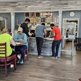 a group of people eating at a restaurant
