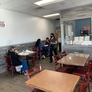 people sitting at tables in a restaurant