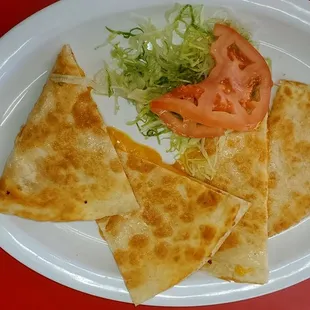 Cheese quesadilla with a little lettuce and tomato