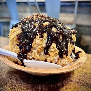 Deep Fried Vanilla ice cream wrapped in corn flakes and Cinnamon Toast Crunch drizzled with chocolate syrup.