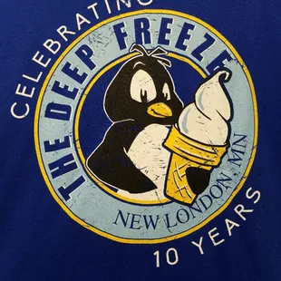 a penguin holding an ice cream cone