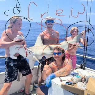 Hammerhead caught by buddies and the crew. Crew are both in the center along with the buddies at each end.