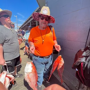 Holding both my wife&apos;s and my fish,