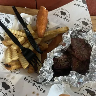 This is the meal portion of brisket along with french fries and those fried things that are not fried pickles!