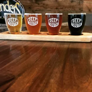 three beers on a wooden tray