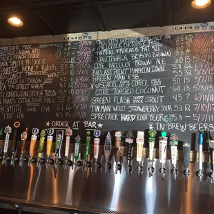 a blackboard with a variety of beers