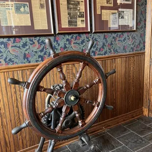 a ship's steering wheel in a restaurant