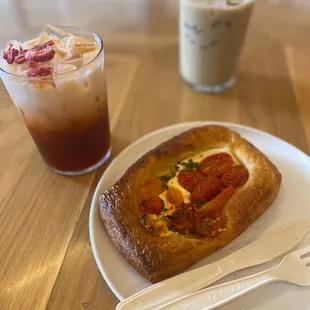Strawberry hibiscus Thai tea, iced latte and tomato and cheese croissant