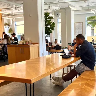 a man sitting at a table using a laptop