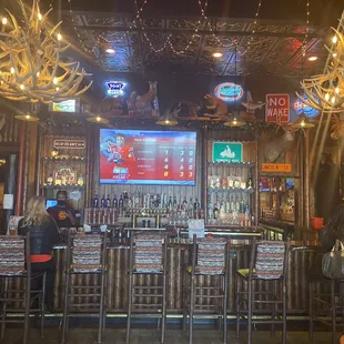 a bar with antlers hanging from the ceiling