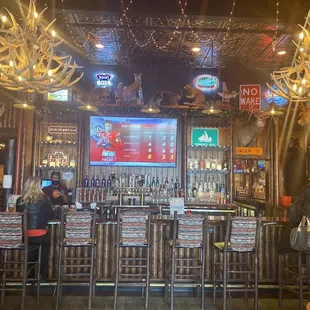 a bar with antlers hanging from the ceiling
