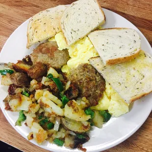 Scrambled eggs, grilled home fries with peppers and onions, sausage patties, and rye toast